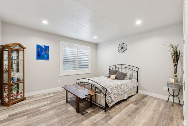 Bedroom with baseboards, recessed lighting, visible vents, and light wood finished floors | Image 27