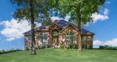 STUNNING LUXURY HOME on 1.27 Acres+/- in Burns!!! 3 Full Bedrooms + 2.5 Bathrooms plus Media Room/4th Space Attached 2-Car Garage + Aggregate Driveway *Note: this photo is edited so home details are visible | Image 1