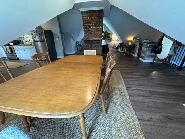 Dining room featuring wood finished floors and lofted ceiling | Image 12