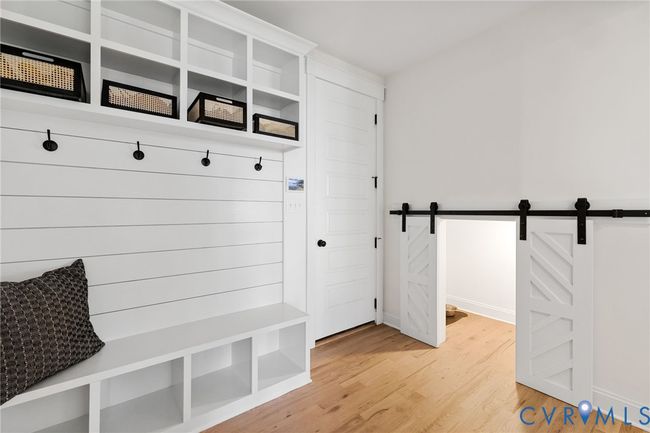Mudroom featuring light wood-type flooring and a barn door | Image 24