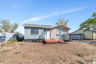 View of front of house with a storage unit and a deck | Image 2