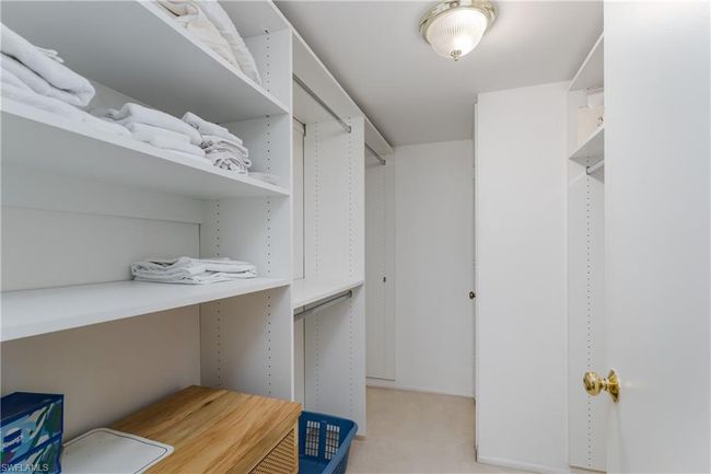 Walk in closet with light carpet | Image 12