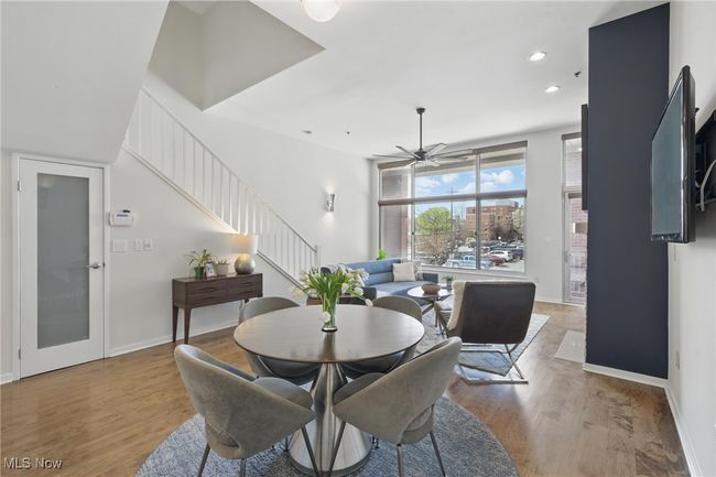 Dining area with ceiling fan, light wood-style flooring, recessed lighting, and stairway | Image 12