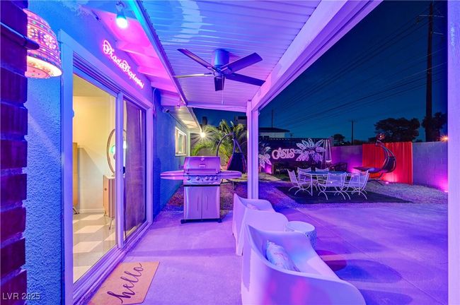 View of patio with outdoor dining space, ceiling fan, and fence | Image 42