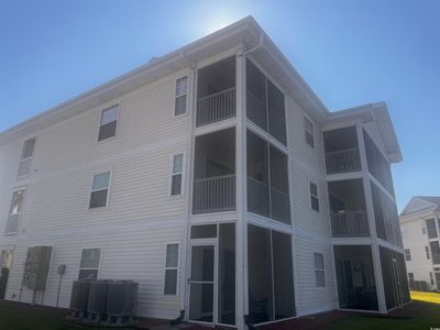 Back of property featuring a balcony and central air condition unit | Image 3