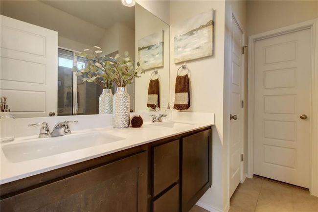 Full bathroom with double vanity, tile patterned flooring, and a shower | Image 21