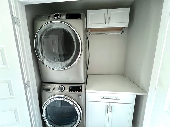 Upstairs laundry with high end washer/dryer, quartz countertop for folding and new cabinetry | Image 38
