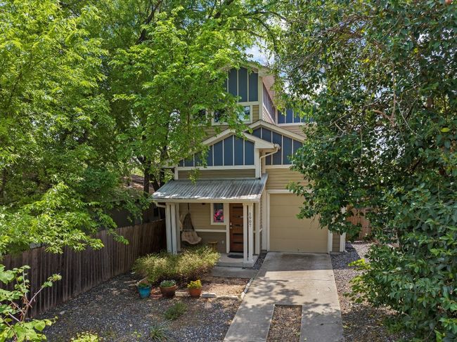 View of front of property featuring an attached garage, fence, covered porch, and driveway | Image 28