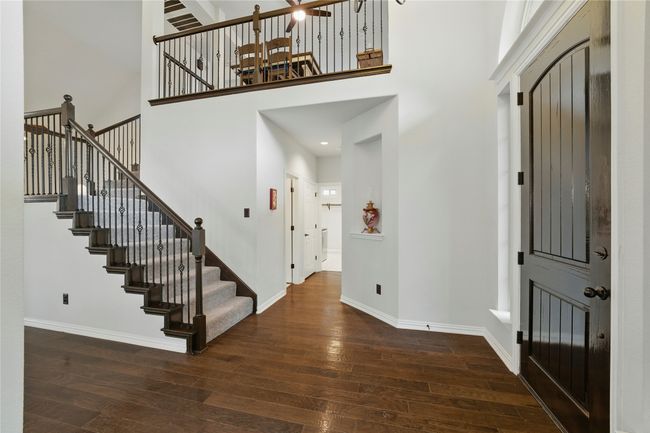 Foyer entrance with a high ceiling, wood-type flooring, and stairs | Image 5