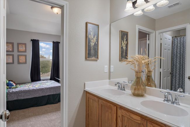Full bathroom featuring double vanity, visible vents, a sink, and ensuite bathroom | Image 23