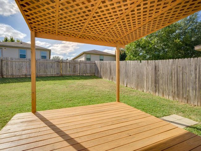 Wooden deck with a fenced backyard. | Image 23