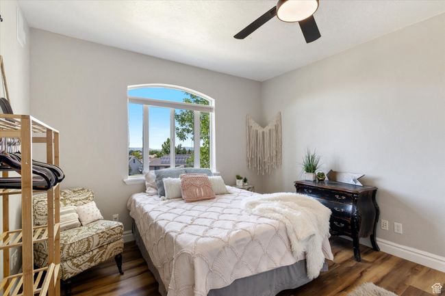 Bedroom with LVP finished floors and a ceiling fan | Image 17