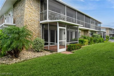 Rear view of house featuring a sunroom and a yard | Image 2