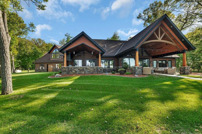 Stunning lakeside view showcasing expertly arranged landscaping, with carefully placed rocks and vibrant flowers that enhance the natural beauty of the surroundings. | Image 12