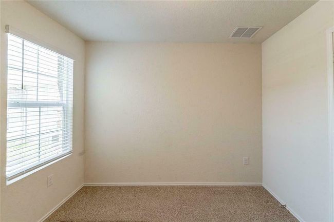 Carpeted spare room with healthy amount of natural light | Image 13