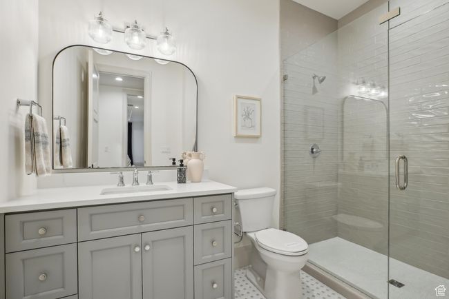 Full bathroom featuring toilet, a shower stall, and vanity | Image 49