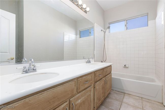 Bathroom featuring a sink, tile patterned floors, double vanity, and shower / bathing tub combination | Image 35