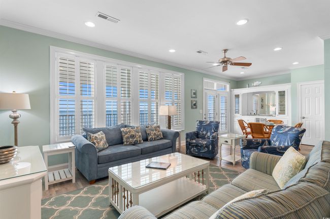 Oceanfront Living area with LVT floors, coastal decor, and plenty of natural light | Image 20