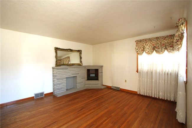 Attractive Stone Decorative Fireplace in Large Living Room | Image 14