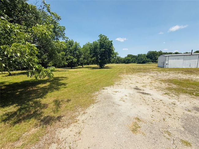 View of green lawn with an outbuilding and a view of rural / pastoral area | Image 8