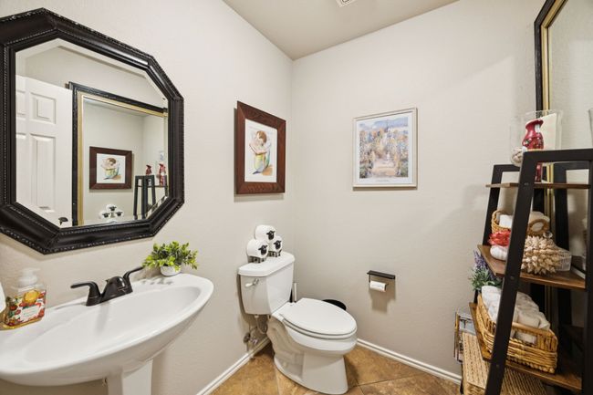 Half Bathroom with a sink and tile patterned floors | Image 22