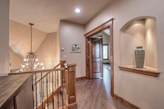 Head upstairs to the top level of the home. You'll find a beautiful hallway with space for artwork to display. | Image 14