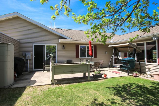 The backyard features an 11'x27' foot concrete patio. | Image 12