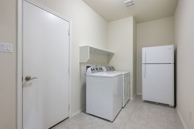 Laundry area with visible vents, independent washer and dryer, laundry area, and light tile patterned flooring | Image 23