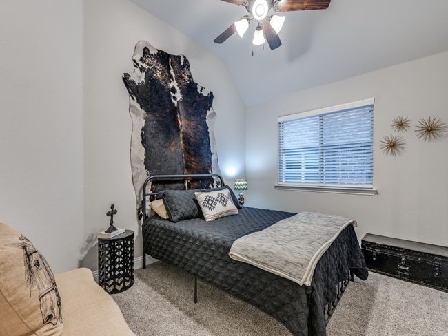 Carpeted bedroom featuring lofted ceiling and ceiling fan | Image 24