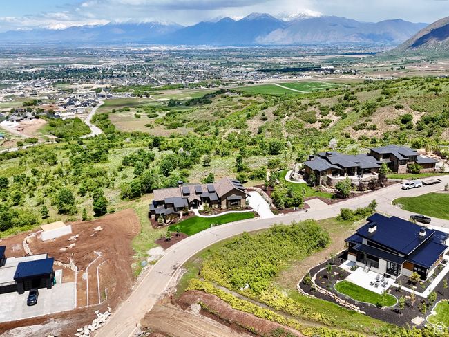 Aerial view of residential area featuring a mountainous background | Image 8