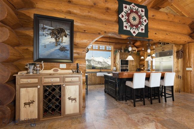 Custom designed bar area and arched kitchen entry. | Image 27