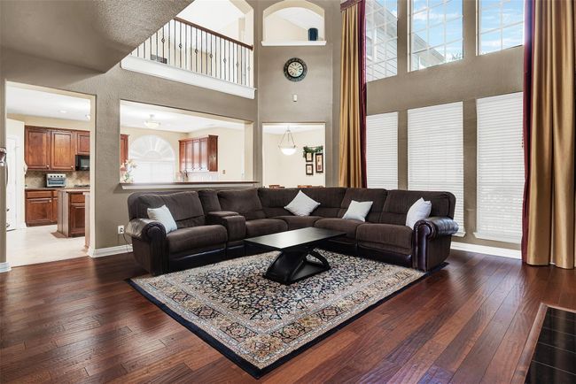 Main living area features fireplace and wall of windows to the pretty backyard | Image 13