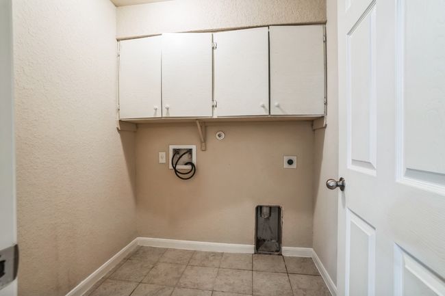 Laundry area with cabinets, washer hookup, and electric dryer hookup | Image 9