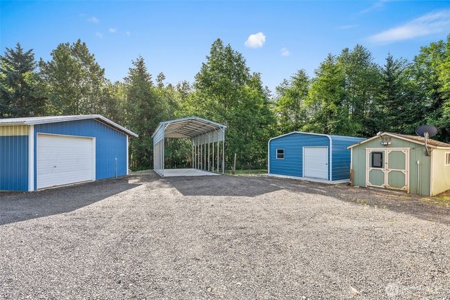 Detached garage, RV Cover, small outbuilding and shed. | Image 25