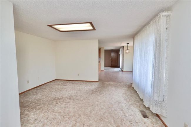 Spare room featuring light colored carpet and a textured ceiling | Image 20