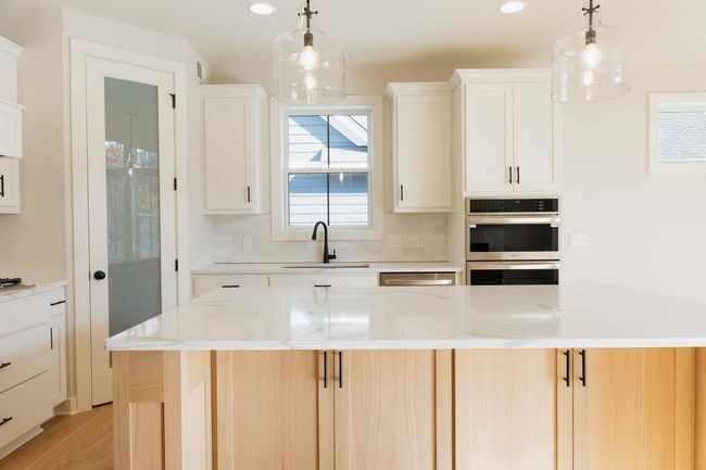 Gourmet Kitchen includes Stainless Steel Hood, and wall Microwave/Oven, large corner pantry and amazing island! Photos may not depict actual home plan configuration. Features/materials/finishes shown contain options that are not included. | Image 6