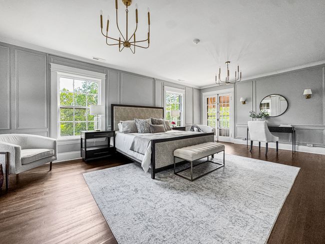 The primary bedroom is a serene retreat with elega | Image 32