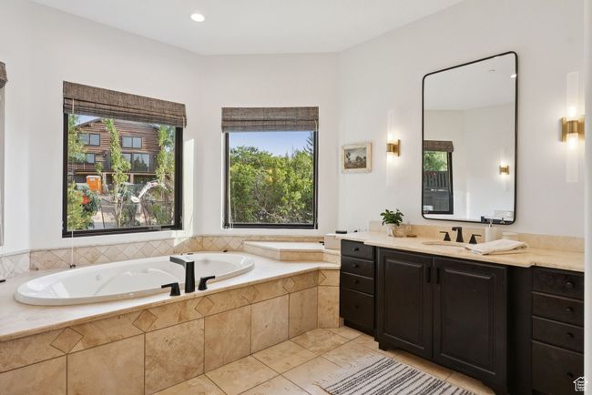 Bathroom with vanity, a bath, tile patterned floors, healthy amount of natural light, and recessed lighting | Image 39