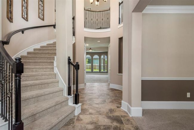 Impressive, grand entrance with 25-foot rotunda ceiling, gorgeous winding staircase and pretty neutral tile floors. | Image 6