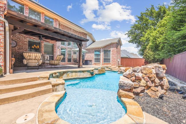 View of swimming pool featuring a patio area | Image 32
