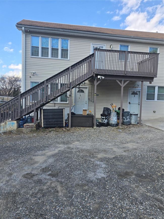 Rear view of property featuring stairway and a deck | Image 6