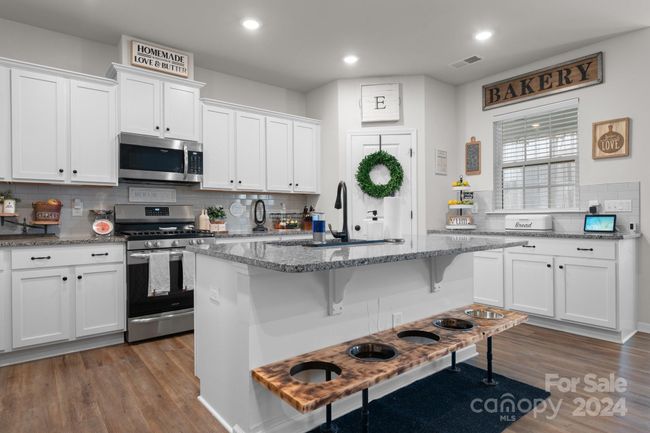 Great kitchen has room for several stools at the counter. All major appliances remain! | Image 13