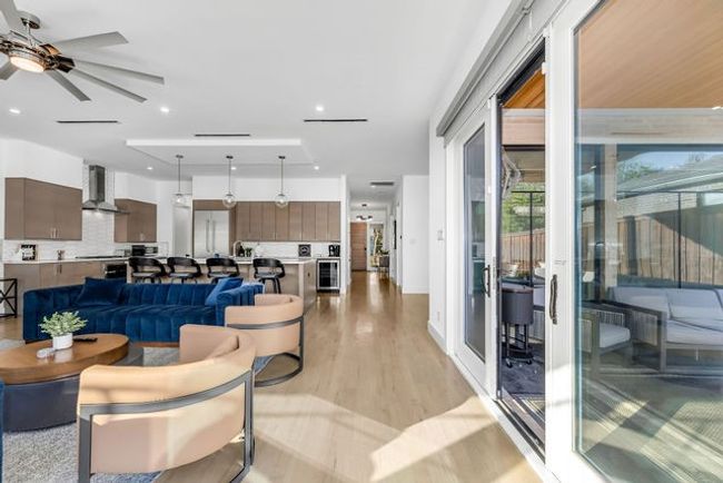 Living room featuring light wood-type flooring and ceiling fan | Image 22
