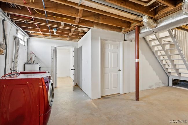 Unfinished basement with water heater, stairway, and washer and dryer | Image 28
