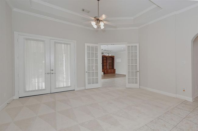Living area with french doors to the great room and to the screened in porch | Image 8