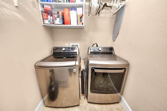 Large, interior laundry room located near the garage, off of the kitchen. | Image 21