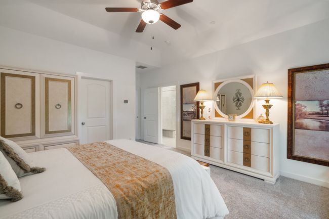 Bedroom featuring carpet floors, lofted ceiling, baseboards, and a ceiling fan | Image 15