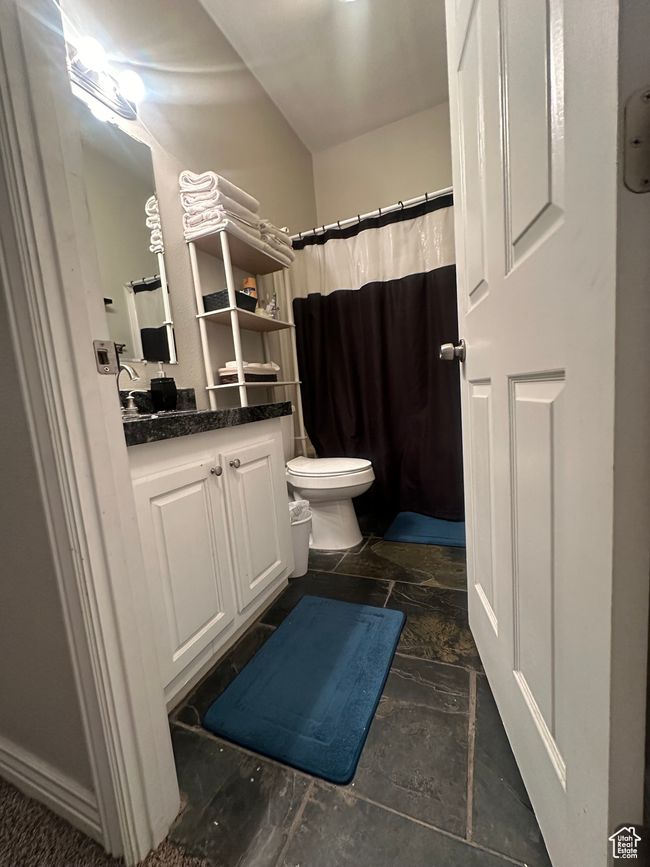 Carpeted bedroom featuring vaulted ceiling | Image 11