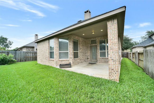 A large covered patio is waiting for some comfy patio furniture for you to enjoy. | Image 27