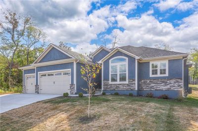 View of front of house featuring a garage and a front lawn | Image 1